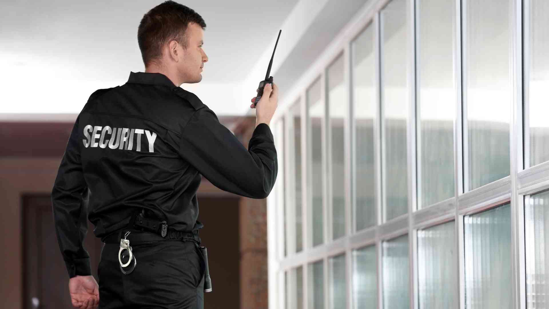 Security person communicating with the team using portable radio 