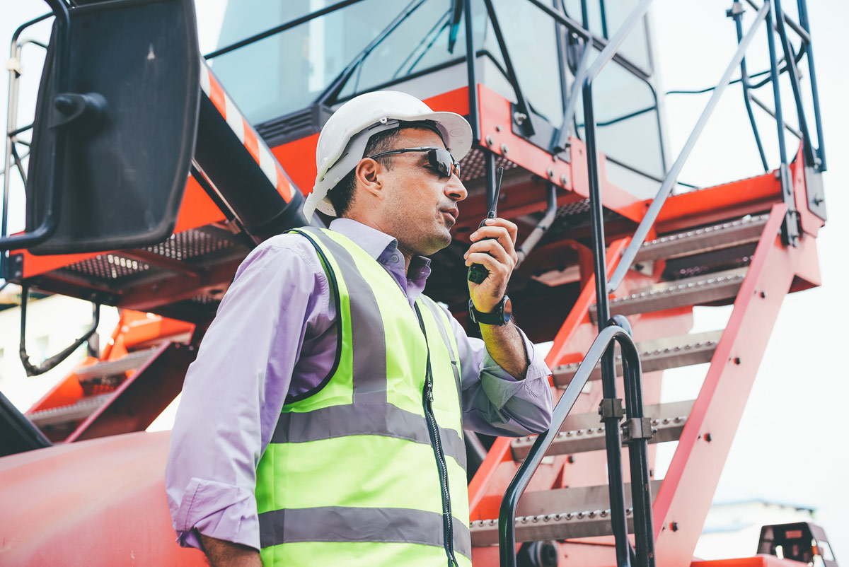 Worker speaking into a portable radio