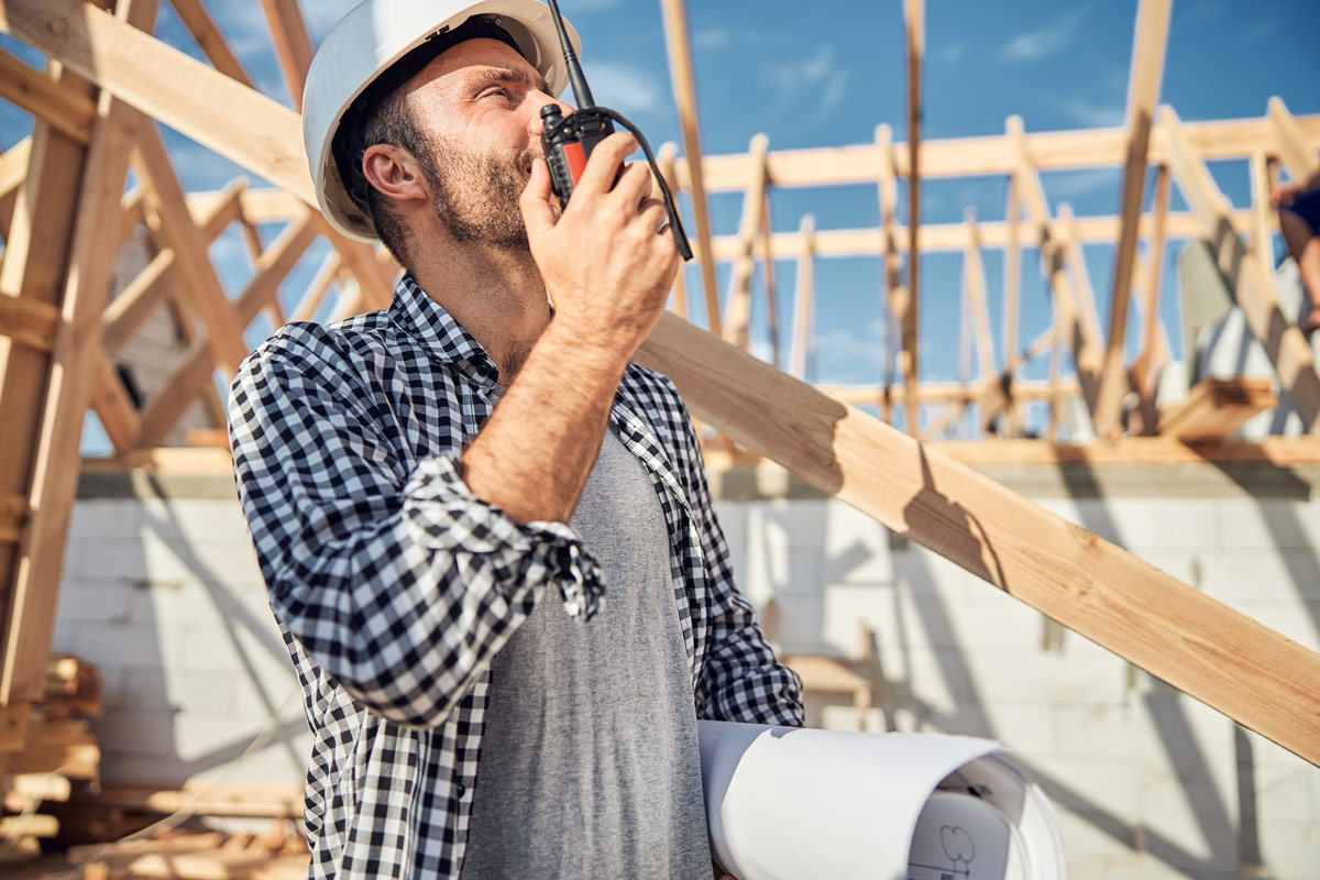 Worker speaking into a portable radio