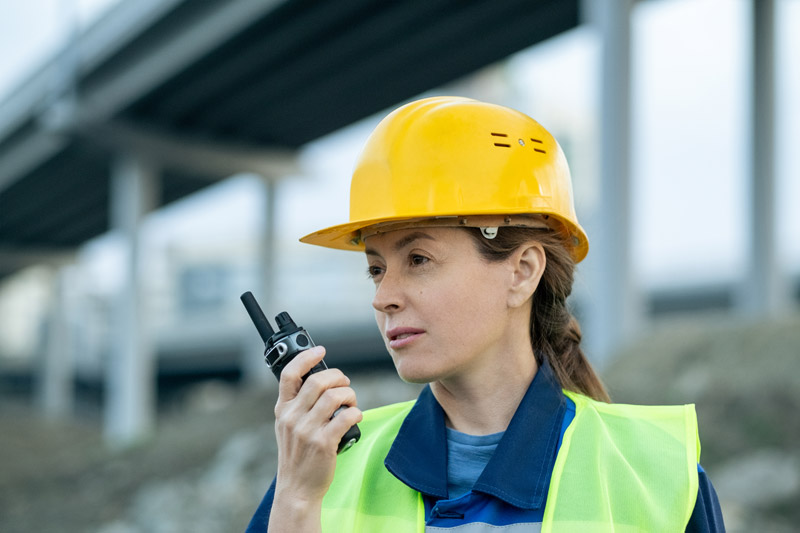 a woman holding two-way radio